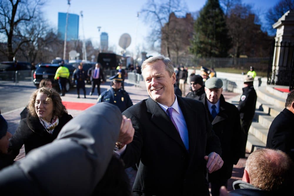 Gov. Charlie Baker greets supporters before walking up the State House steps for his inauguration. (Jesse Costa/WBUR)