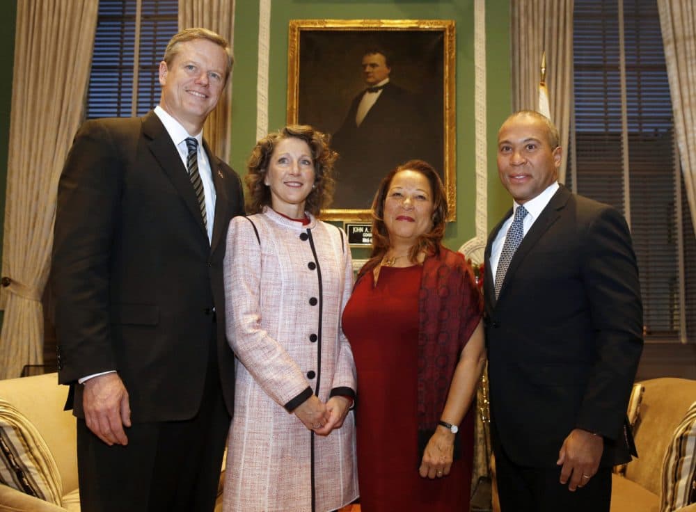 Governor-elect Charlie Baker, left, and his wife, Lauren, pose for a photo with Gov. Deval Patrick and his wife, Diane, in the Governor's Office at the State House, in Boston Wednesday. (Angela Rowlings/The Boston Herald/AP)