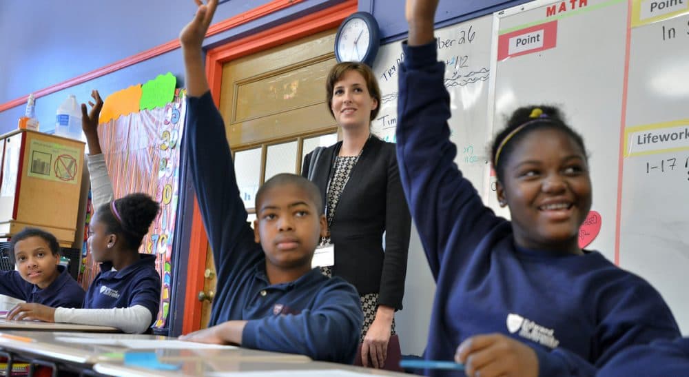 Richard Whitmire: It's time to drop the limits entirely and shift to a system that focuses on building high performing schools, both charter and traditional. Pictured: Students at Boston's Brooke Charter School participate in class. (Josh Reynolds/AP)