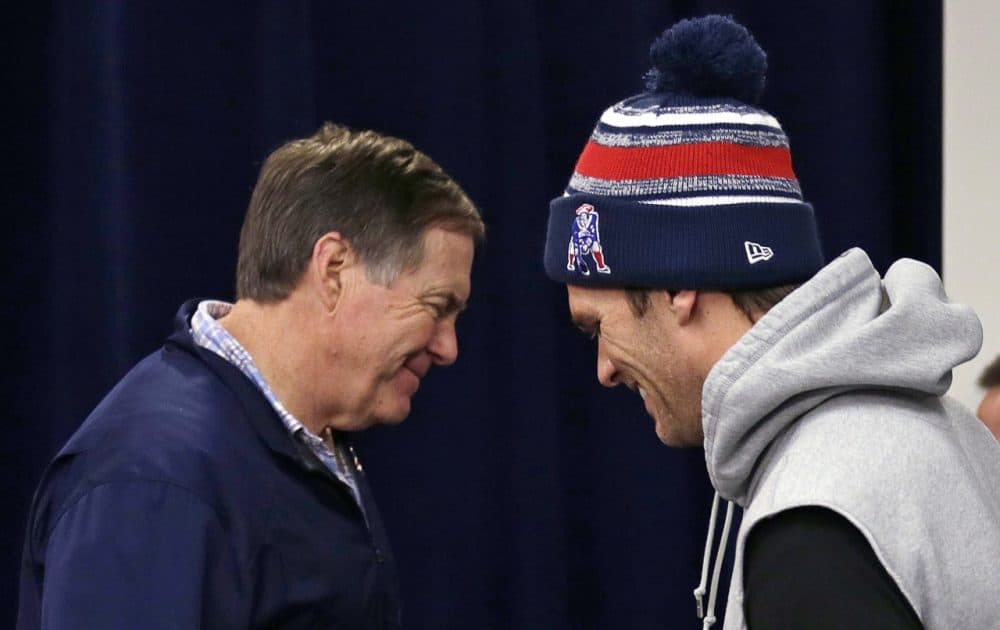 New England Patriots head coach Bill Belichick, left, and quarterback Tom Brady cross paths during a news conference prior to a team practice in Foxborough, Mass. on Wednesday. (Charles Krupa/AP)