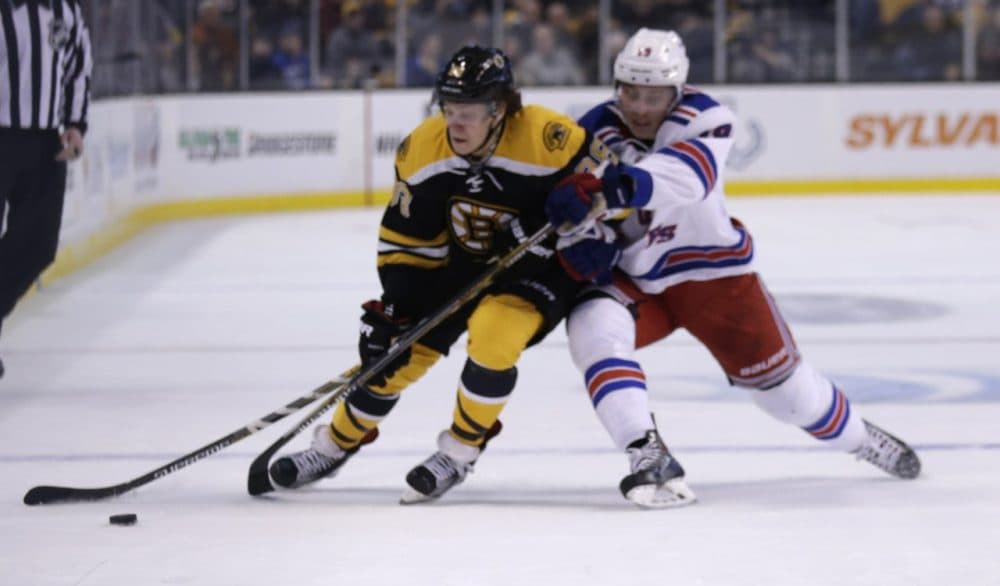 Boston Bruins left wing David Pastrnak (88) tries to elude New York Rangers right wing Jesper Fast (19) during the second period of an NHL hockey game in Boston on Thursday. (Charles Krupa/AP)