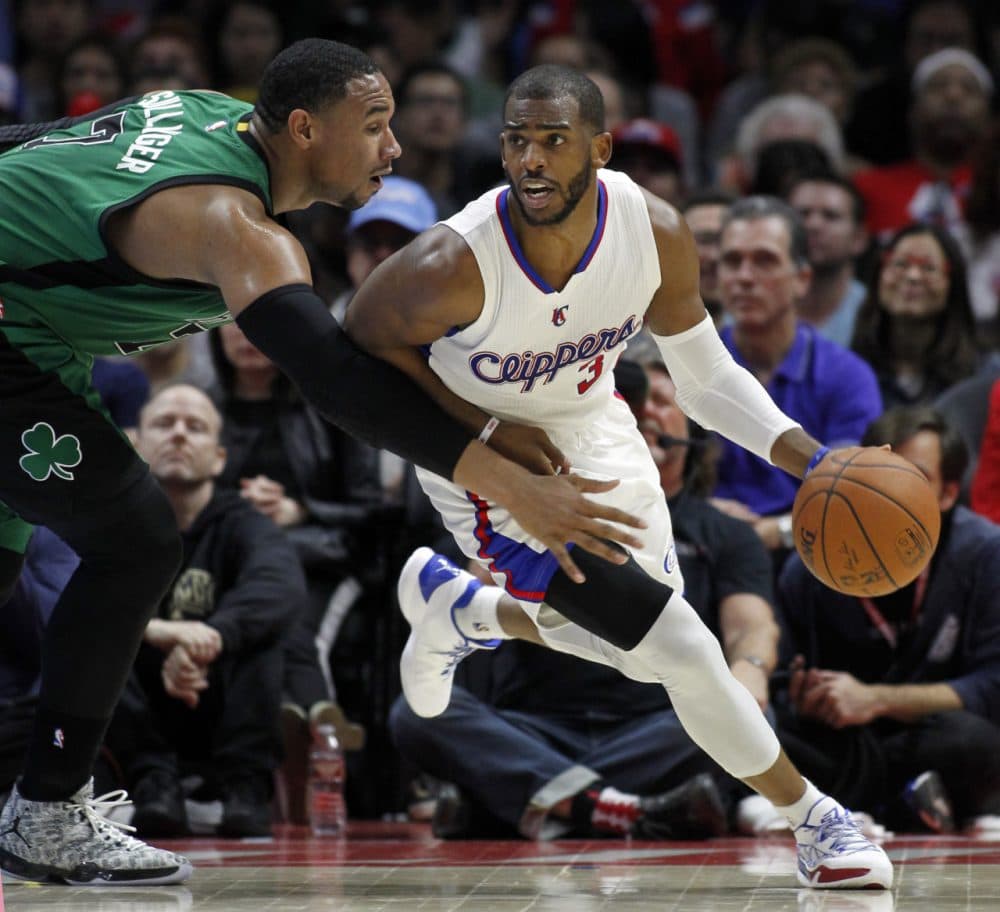 Boston Celtics forward Jared Sullinger, left, reaches in as Los Angeles Clippers guard Chris Paul dribbles away from the pressure. (Alex Gallardo/AP)