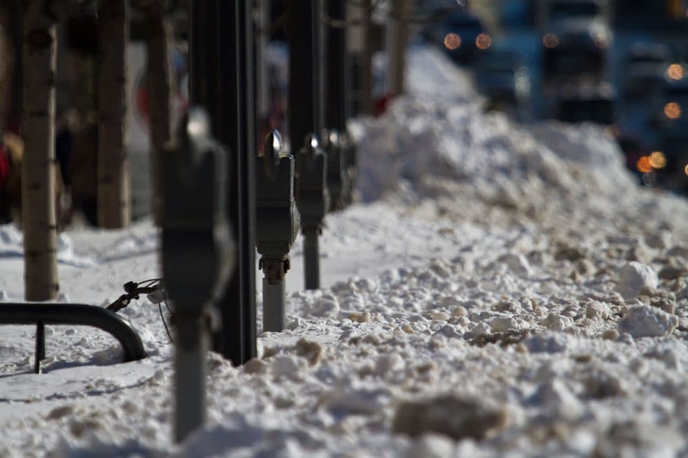 Several parking meters were buried in snow along Commonwealth Ave. as Boston continued snow removal efforts following a blizzard on Jan. 27, 2015. (Jesse Costa/WBUR)