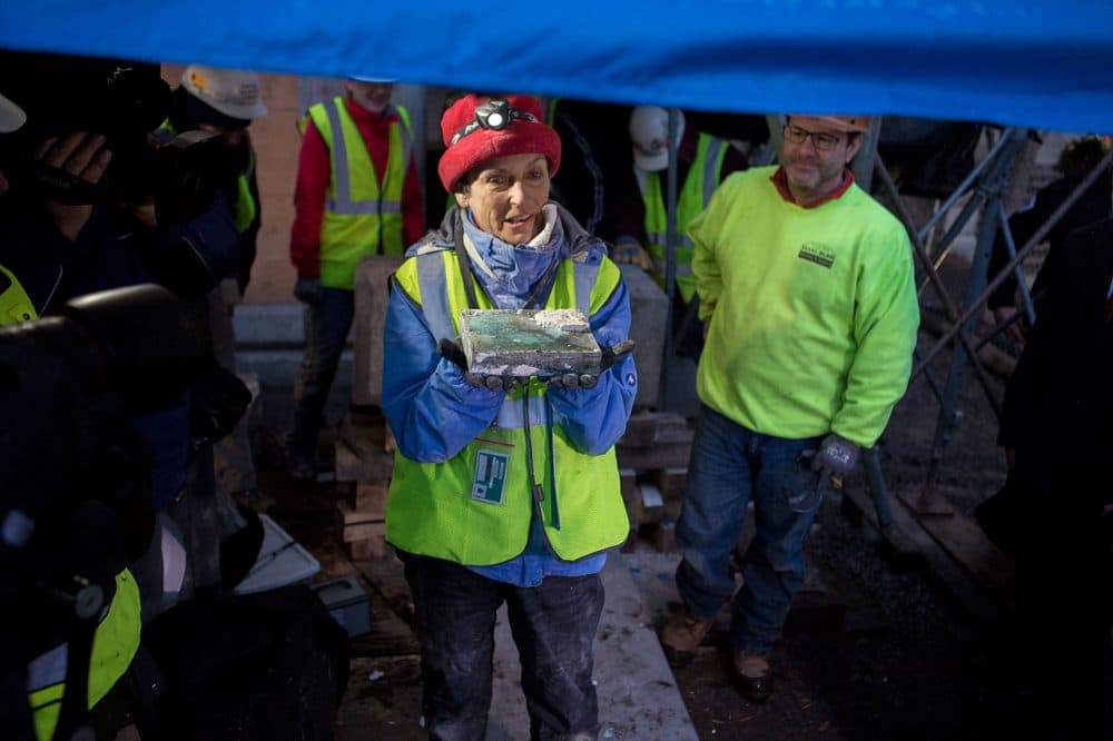 Pamela Hatchfield, head of objects conservation at the MFA, held the time capsule after extracting it from the cornerstone of the State House in December. (Jesse Costa/WBUR)
