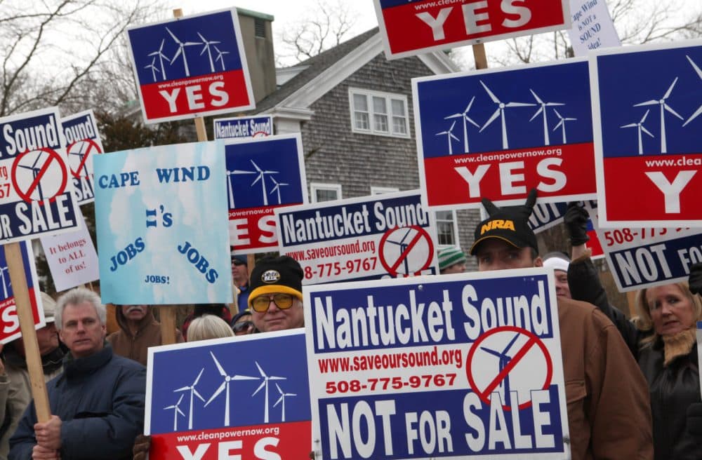 Supporters and opponents of Cape Wind protest outside the Coast Guard Station in Woods Hole in February 2010. (AP)