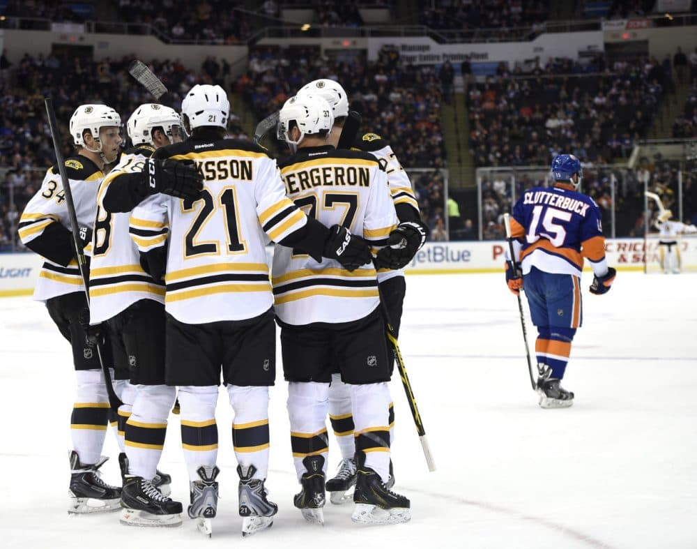 Boston Bruins center Patrice Bergeron (37) celebrates his goal with center Carl Soderberg (34), right wing Reilly Smith (18), left wing Loui Eriksson (21) and defenseman Dougie Hamilton (27) as New York Islanders right wing Cal Clutterbuck (15) skates away during Thursday night's game at Nassau Coliseum on Thursday, Jan. 29, 2015, in Uniondale, N.Y. (Kathy Kmonicek/AP)