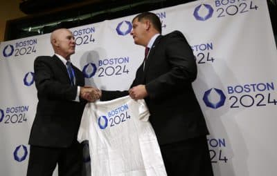 Boston Mayor Marty Walsh, right, is presented with a tee shirt by Ralph Cox, an organizer pursuing an Olympics bid, during an event held to generate public interest in a 2024 Olympics bid for the city of Boston, Monday, Oct. 6, 2014, in Boston. The U.S. Olympic Committee is weighing whether to put in a bid for the 2024 Summer Games. (AP)