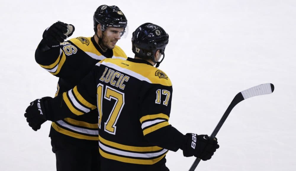 Boston Bruins left wing Milan Lucic (17) gets a pat on the back from teammate David Krejci after his goal during the first period of an NHL hockey game against the New Jersey Devils in Boston, Thursday, Jan. 8, 2015. (Charles Krupa/AP)