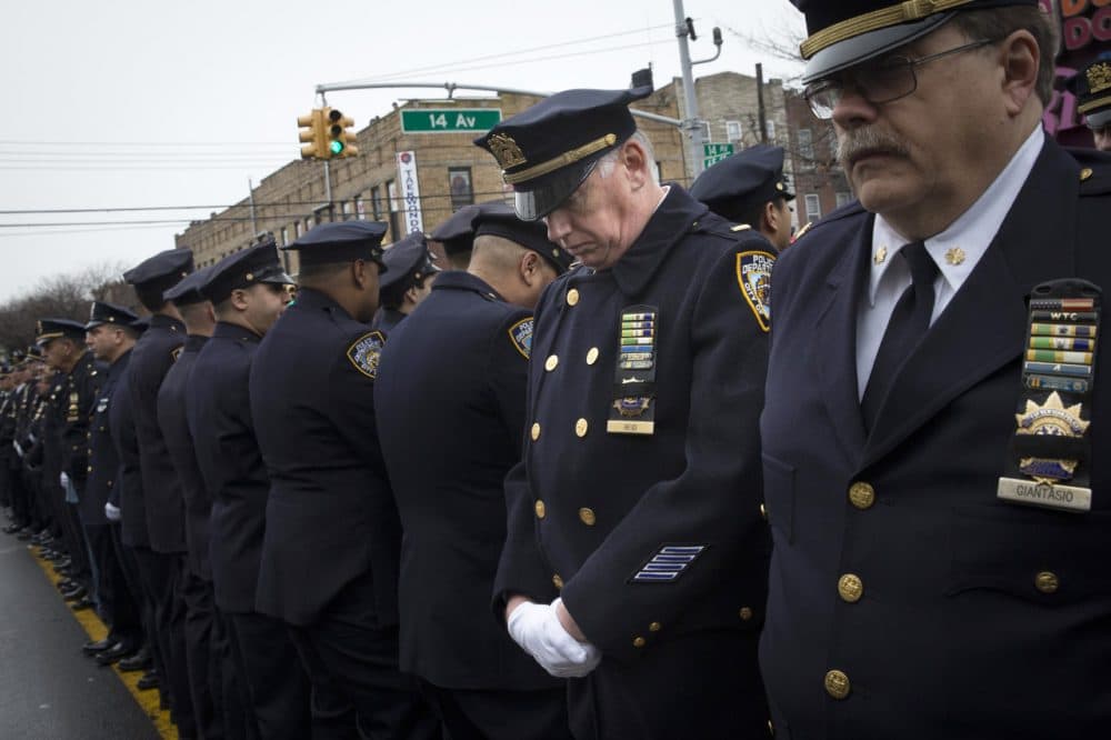 Some police officers turn their backs as Mayor Bill de Blasio speaks during the funeral of NYPD Officer Wenjian Liu. (John Minchillo/AP)