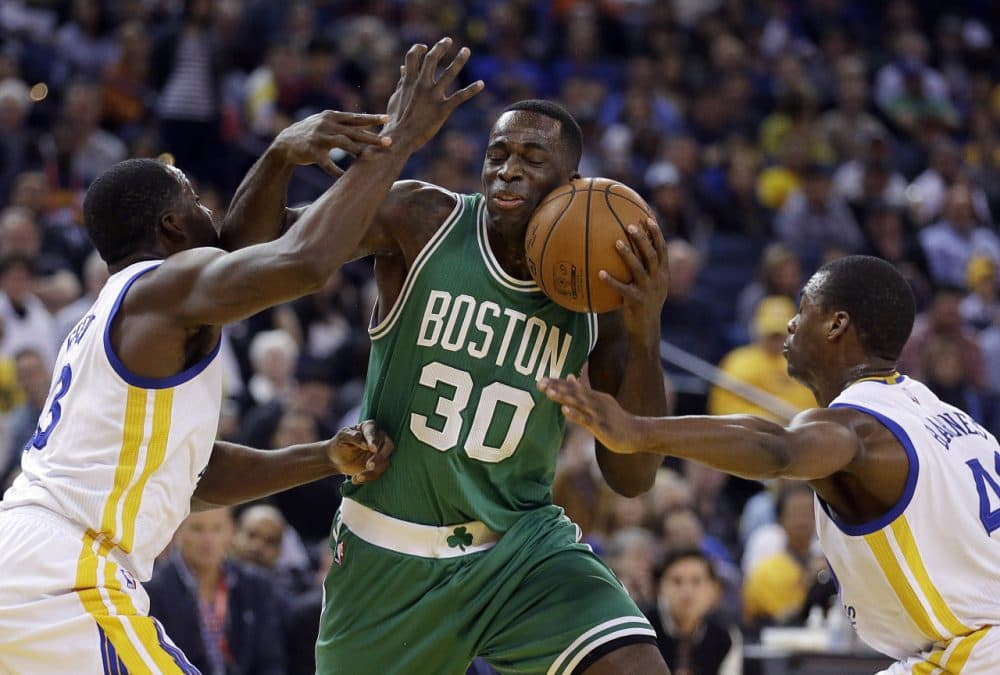 Boston Celtics' Brandon Bass (30) is guarded by Golden State Warriors' Draymond Green, left, and Harrison Barnes during Sunday night's game on Jan. 25, 2015, in Oakland, Calif. (Ben Margot/AP)