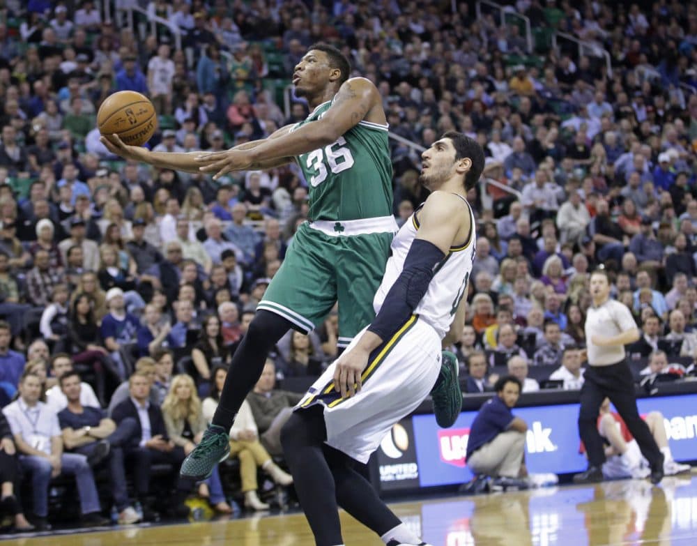 Boston Celtics guard Marcus Smart (36) lays the ball up as Utah Jazz center Enes Kanter, right, defends during Monday night's game on Jan. 26, 2015, in Salt Lake City.  (Rick Bowmer/AP)