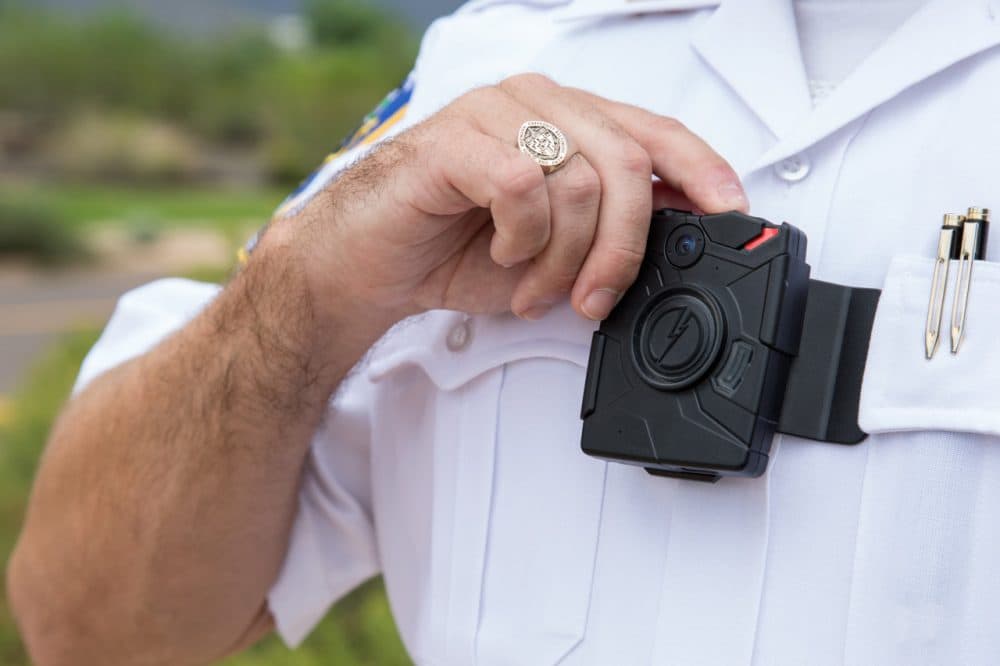A lieutenant in the Riverdale Park Police Department in Maryland demonstrates how to use a body camera made by TASER. (TASER)