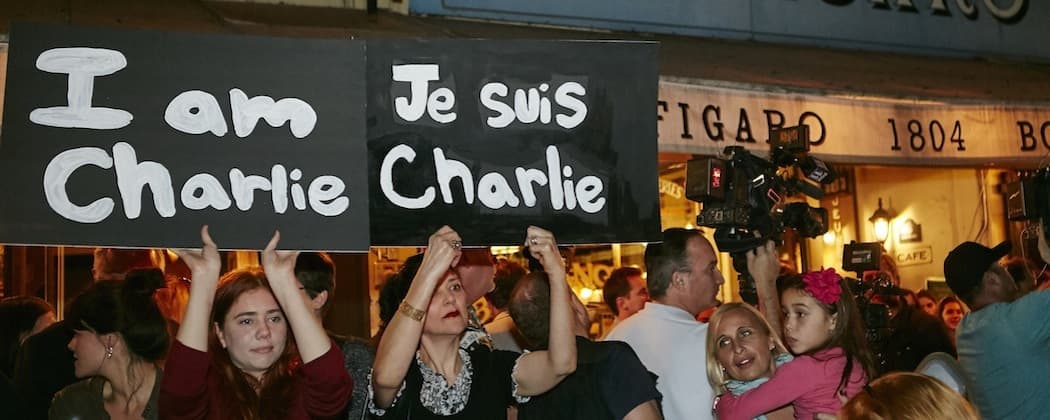 Members of the French-American community of Los Angeles hold signs reading &quot;I'm Charlie,&quot; &quot;Je Suis Charlie,&quot; at a gathering  outside of the French restaurant &quot;Figaro&quot; in Los Angeles. (Damian Dovarganes/AP)