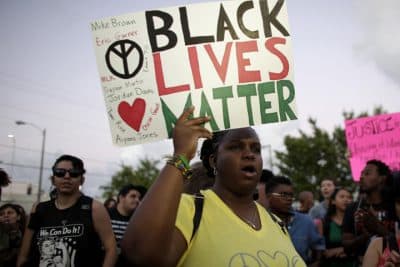 Desiree Griffiths, 31, of Miami, holds up a sign saying &quot;Black Lives Matter&quot;, with the names of Michael Brown and Eric Garner, two black men recently killed by police, during a protest Friday, Dec. 5, 2014, in Miami.  (AP)