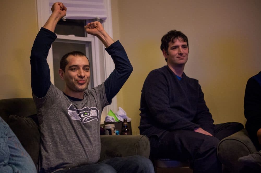 Navad Tanners, left, has called Boston home for seven years but grew up in Spokane, Washington.  He hosted a dozen friends for Sunday's Super Bowl game. (Jesse Costa/WBUR) 
