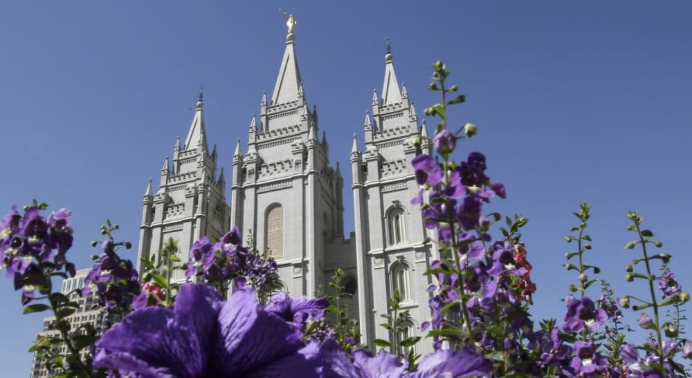 In this Sept. 3, 2014 photo, flowers bloom in front of the Salt Lake Temple. Mormon church leaders are making a national appeal for a &quot;balanced approach&quot; in the clash between gay rights and religious freedom. The church is promising to support some housing and job protections for gays and lesbians in exchange for legal protections for believers who object to the behavior of others. (Rick Bowmer/AP)