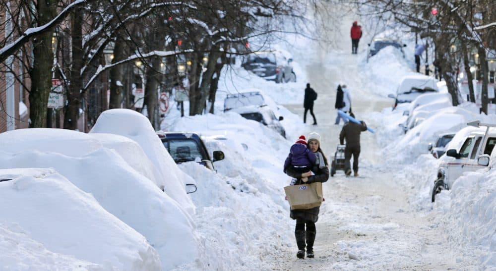 With all the snow lately, many of us have grappled with how to get to and from work. Some, more than others. In this photo, a woman carries a toddler in Boston, Tuesday, Feb. 3, 2015. The area has received about 40 inches of snow in the past week. (Charles Krupa/AP)