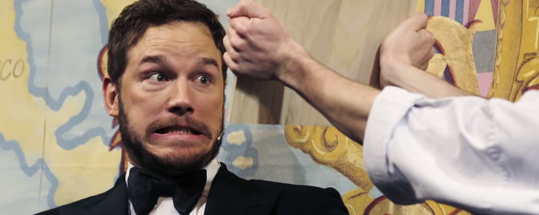Actor Chris Pratt gets ready to break a board with his head during the roast at Harvard University, where he was honored as &quot;Man of the Year&quot; by the Hasty Pudding Theatricals. (Charles Krupa/AP)