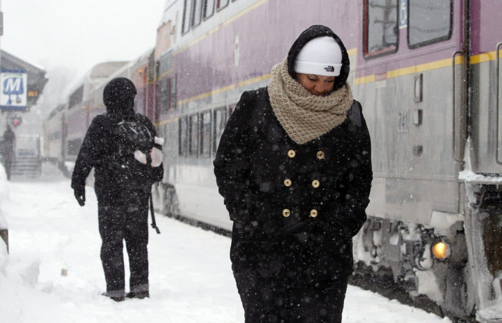 Passengers wait at the commuter rail train station Monday in Framingham. 