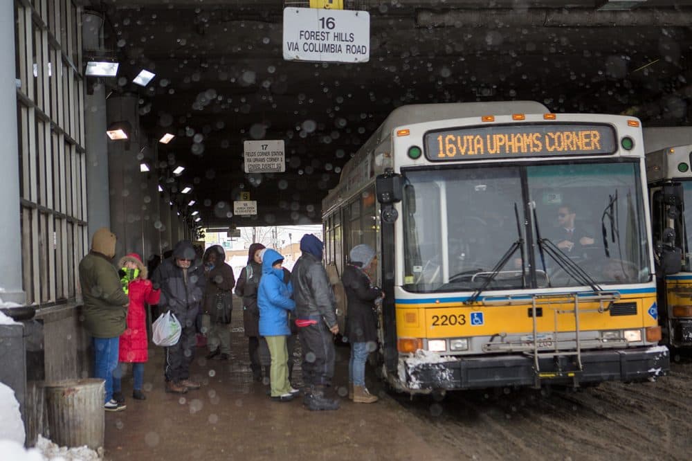 Commuters get on the 16 bus to Forest Hills at Andrew Square station Tuesday. (Jesse Costa/WBUR)