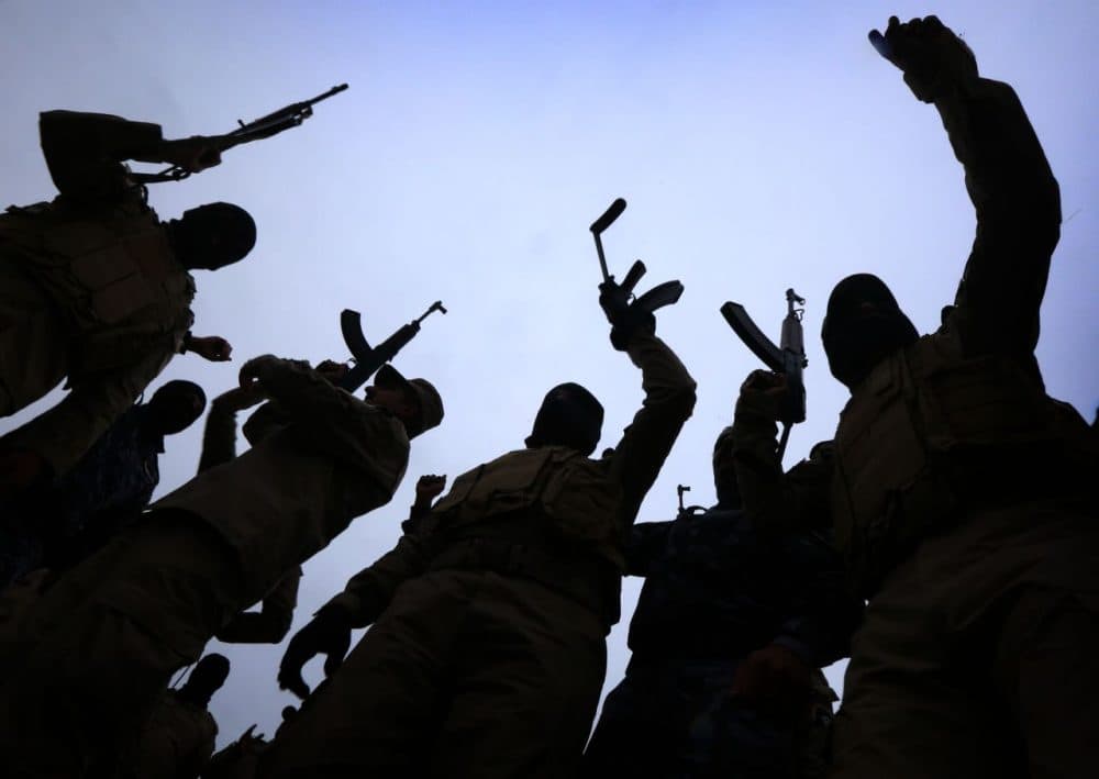 Iraqi policemen raise their weapons during a training session at a camp in the Bardarash district, 30 kilometres northeast of Mosul on January 10, 2015 as they prepare to recapture the northern Iraqi city of Mosul, currently under the control of Islamic State (ISIS) group fighters. ISIS spearheaded a sweeping militant offensive in June that overran large areas north and west of Baghdad, and also holds significant territory in Iraq and Syria. (Safin Hamed/AFP/Getty Images)