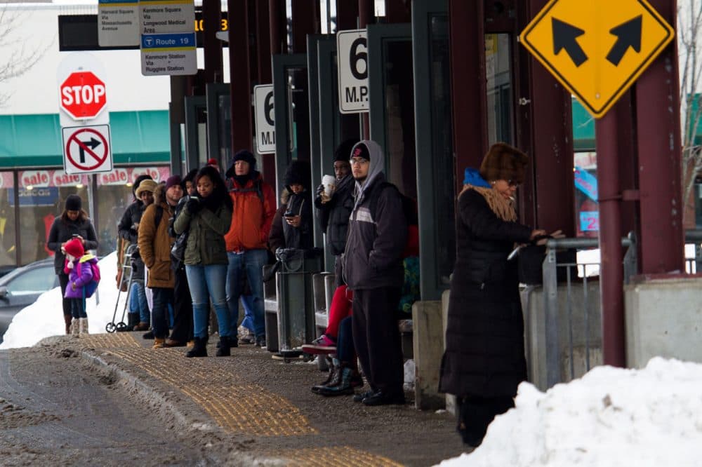 Commuters wait for buses at Dudley MBTA Station. (Jesse Costa/WBUR)