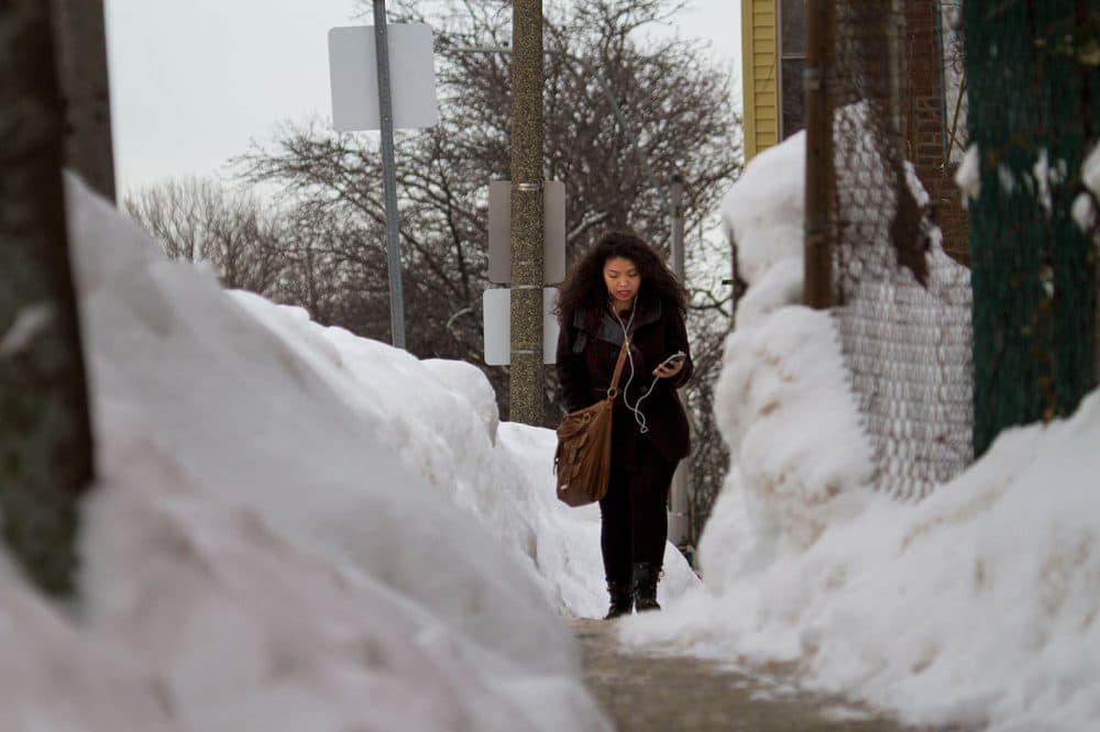 Shaena Sandoval walks through a narrow path on Maverick Street Thursday on her way to school. 