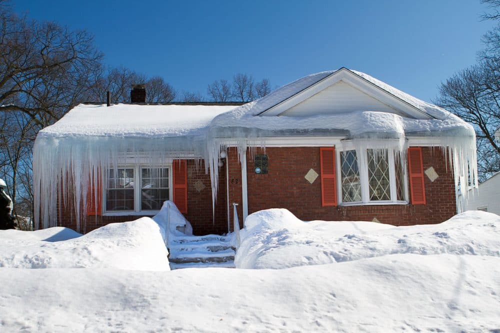A house on Woodhaven Street in Mattapan with lots of excessive snow and ice on the roof. (Jesse Costa/WBUR)