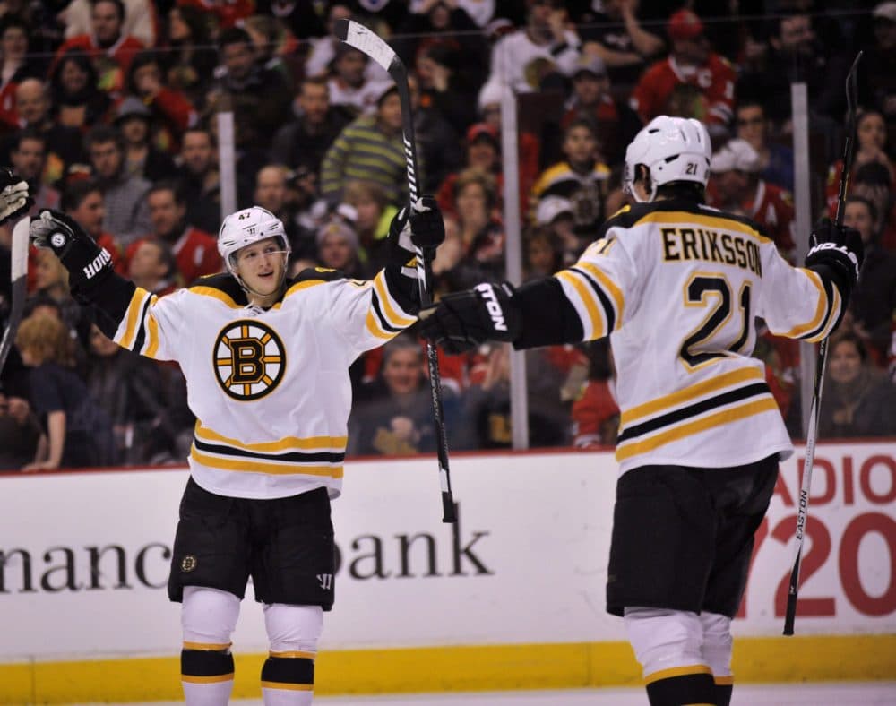 Bruins' Tony Krug (47), celebrates with teammate Loui Eriksson (21), after Eriksson scored a goal during the first period Sunday. (Paul Beaty/AP)