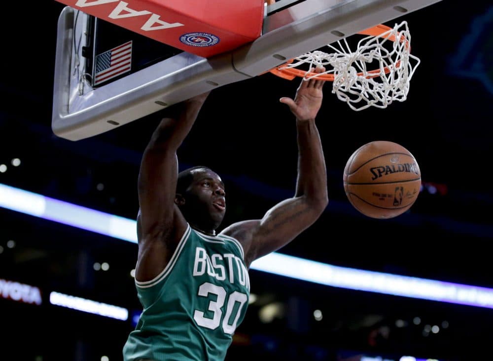 Celtics center Brandon Bass scores against the Lakers during the first half of Sunday's game in Los Angeles. (Chris Carlson/AP)