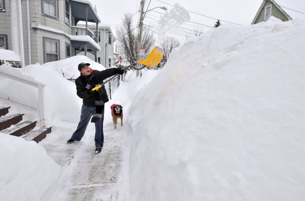 Lee Anderson shoveled in front of his house in Somerville on Feb. 10, 2015, after a storm dumped another two feet of snow and forced the MBTA to suspend all rail service for the day. (Josh Reynolds/AP)