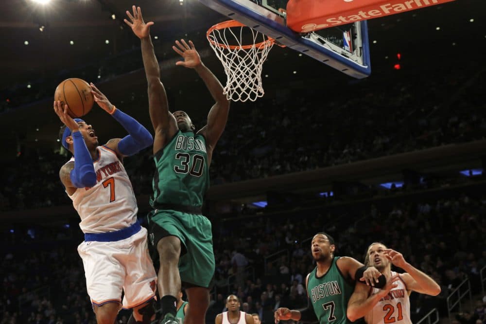 New York Knicks forward Carmelo Anthony (7) goes up against Boston Celtics forward Brandon Bass (30) during Tuesday night's game on Feb. 3, 2015 at Madison Square Garden in New York.  (Mary Altaffer/AP)