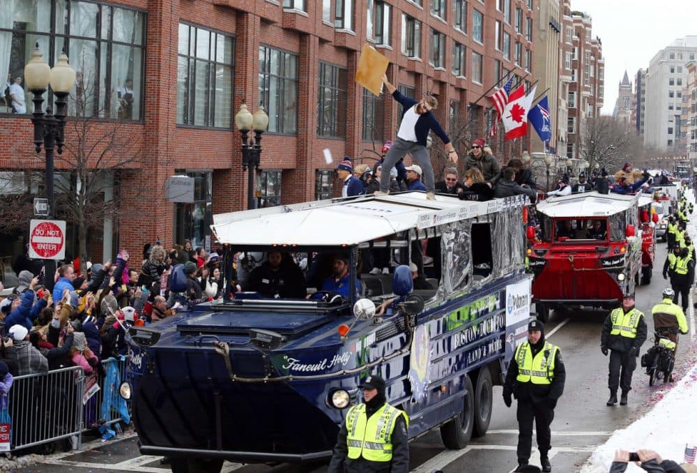 Patriots receiver Julian Edelman responds to cheers from the crowd from atop a duck boat. (Winslow Townson/AP)
