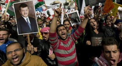 Demonstrators chant anti-Islamic State group slogans and carry posters with pictures of Jordanian King Abdullah II, late King Hussein and slain Jordanian pilot, Lt. Muath al-Kaseasbeh, during an anti-ISIS rally in Amman, Jordan, Friday, Feb. 6, 2015. Several thousand people marched after Muslim Friday prayers in support of the king's pledge of a tough military response to the killing of the pilot. (Nasser Nasser/AP)