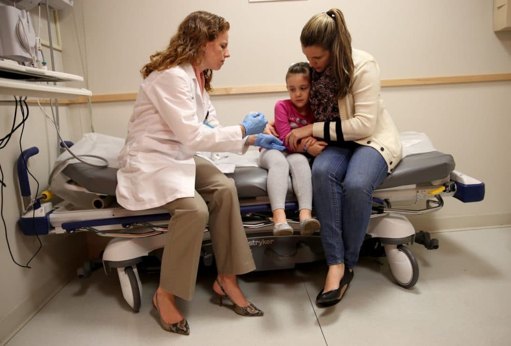 Miami Children's Hospital pediatrician Dr. Amanda Porro, M.D prepares to administer a measles vaccination to Sophie Barquin,4, as her mother Gabrielle Barquin holds her during a visit to the Miami Children's Hospital on January 28, 2015 in Miami, Florida. A recent outbreak of measles has some doctors encouraging vaccination as the best way to prevent measles and its spread. (Joe Raedle/Getty Images)