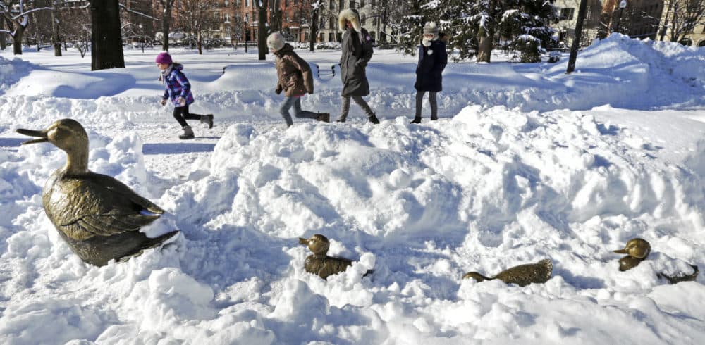 Children run through the Boston Public Garden, passing the nearly snow-covered &quot;Make Way for Ducklings&quot; statues, after the last major snowstorm. The city is bracing for another couple feet of snow. (Charles Krupa/AP)