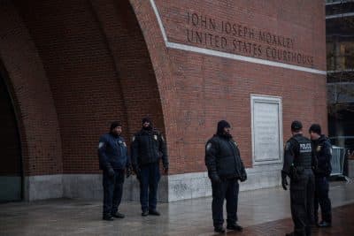 Law enforcement officials stand guard outside the Joseph Moakley United States Courthouse on January 4, 2015 in Boston. (Andrew Burton/Getty Images)