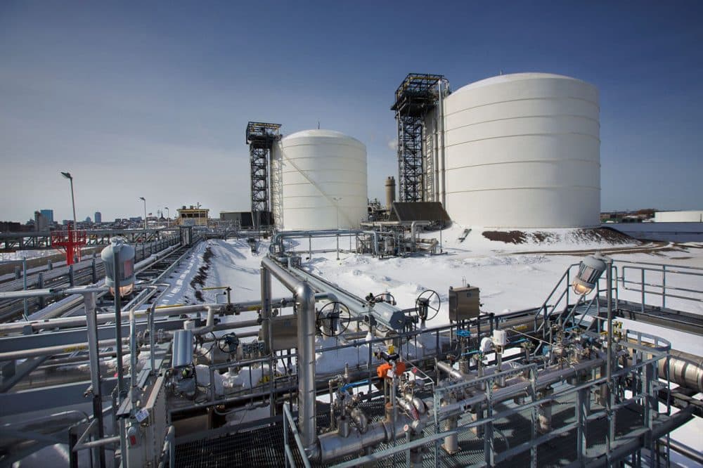 The Everett Distrigas liquefied natural gas terminal, with Boston in the background to the left. The two LNG tanks contain the equivalent amount of gas to heat and light all of Massachusetts for a day. (Jesse Costa/WBUR)