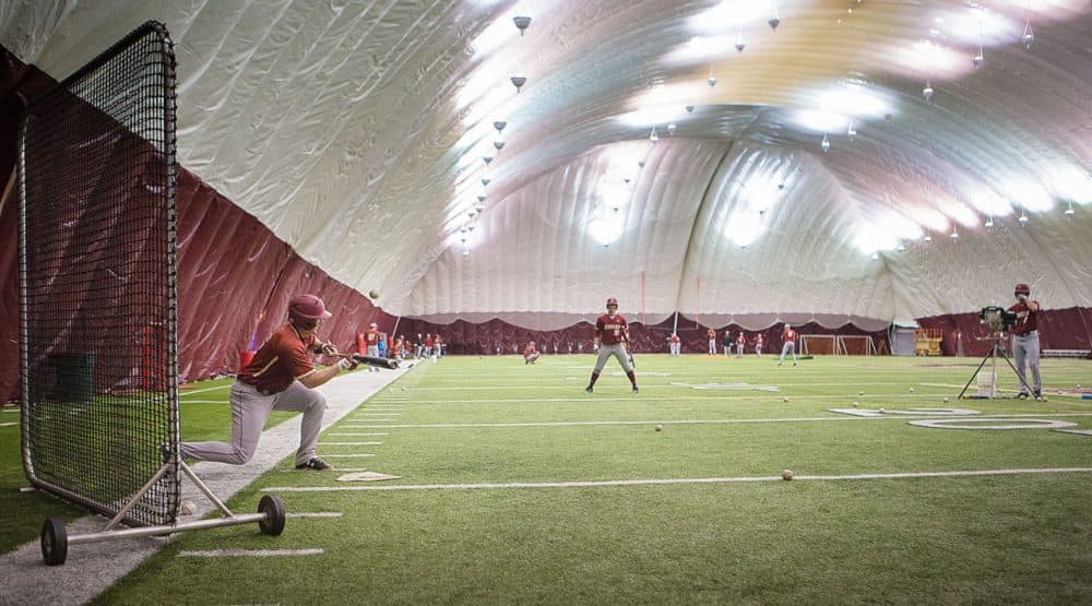 This winter's record-breaking snowfall has some college sports teams wondering where they will be playing their first spring games, including Boston College's baseball team, pictured here during a practice earlier this week. (Jesse Costa/WBUR)