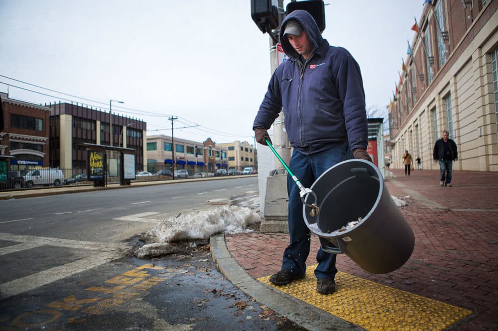 Mike Sisti, of the Boston University Facilities Department, picks up trash along Commonwealth Avenue on Friday. (Jesse Costa/WBUR)