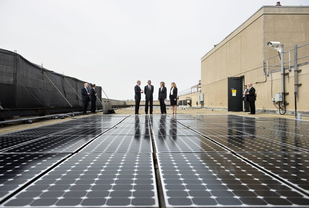 US President Barack Obama (2L), Department of Energy Deputy Secretary Liz Sherwood-Randall (2R) and Federal Chief Sustainability Officer Kate Brandt (R) listen while Eric Haukdal, an energy manager at the Department of Energy headquarters, speaks about the solar panels on the roof at the Department of Energy, March 19, 2015 in Washington, DC. (Brendan Smialowski/AFP/Getty Images)