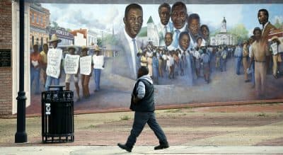 A Port Gibson, Miss., resident walks past a mural depicting a successful economic boycott protest in the 1960's, Monday, March 23, 2015. A small group of residents and friends gathered nearby to show support for the Otis Byrd's family and to call on federal and state authorities to do a thorough investigation into his death. Byrd's body was found last Thursday, hanging from a sheet from a tree in a rural area outside of Port Gibson. The FBI is consulting with its behavioral analysis unit as it continues investigating the hanging death of Byrd. (Rogelio V. Solis/AP)