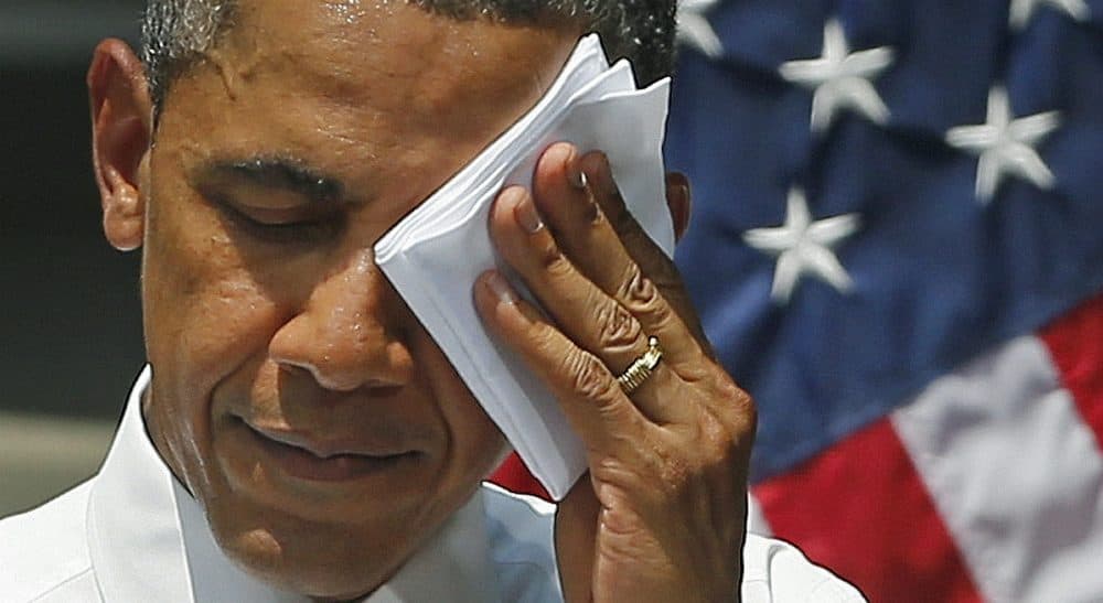 President Obama has the chance to implement a legally binding deal on greenhouse gas reductions, without being hamstrung by a recalcitrant Congress. In this photo, Obama wipes sweat from his brow during a speech on climate change at Georgetown University in July 2013. (Evan Vucci/AP)
