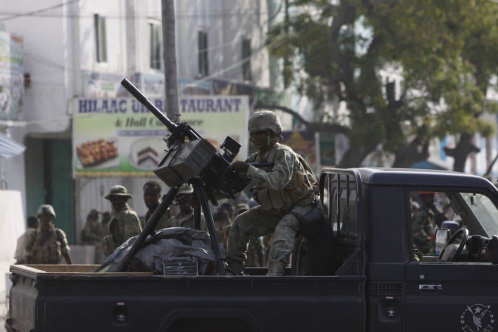 A Somali soldier takes position during fighting with militants who were inside the Maka Almukaramaha Hotel in Mogadishu, Somalia. (Farah Abdi Warsameh/AP)