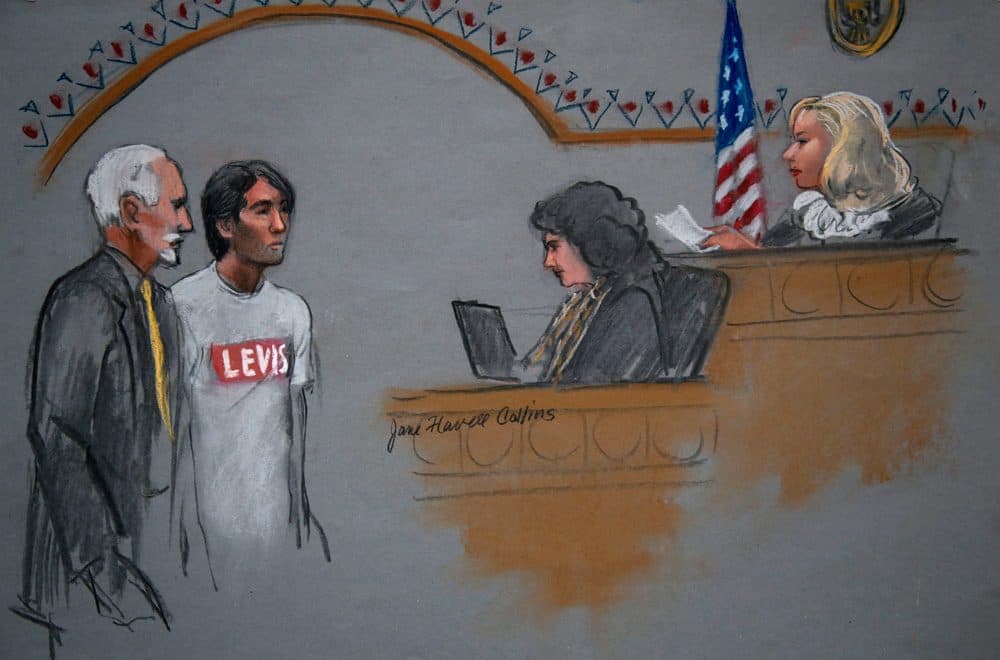 In this 2014 courtroom sketch, Khairullozhon Matanov, second from left, with attorney Paul Glickman, left, appears in federal court in Boston before Magistrate Judge Marianne Bowler. (Jane Flavell Collins/AP)