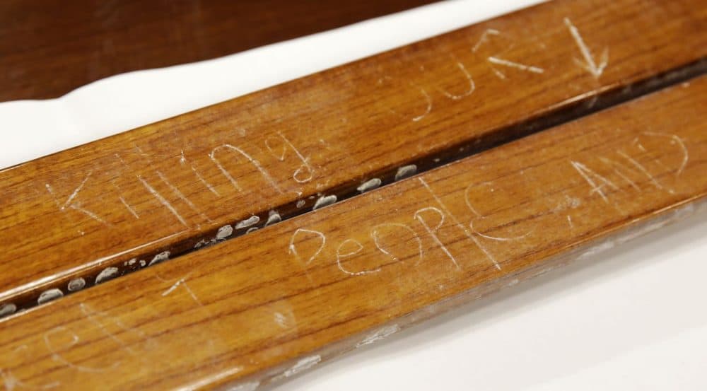 Wood from the power boat where Dzhokhar Tsarnaev was found hiding, etched with many words including &quot;killing our people&quot;, is displayed in a conference room at the John Joseph Moakley United States Courthouse in Boston, Tuesday, March 17, 2015. The wooden pieces were presented to a jury in Tsarnaev's federal death penalty trial. Tsarnaev is charged with conspiring with his brother to place two bombs near the Boston Marathon finish line that killed three and injured 260 spectators in April 2013. (AP )