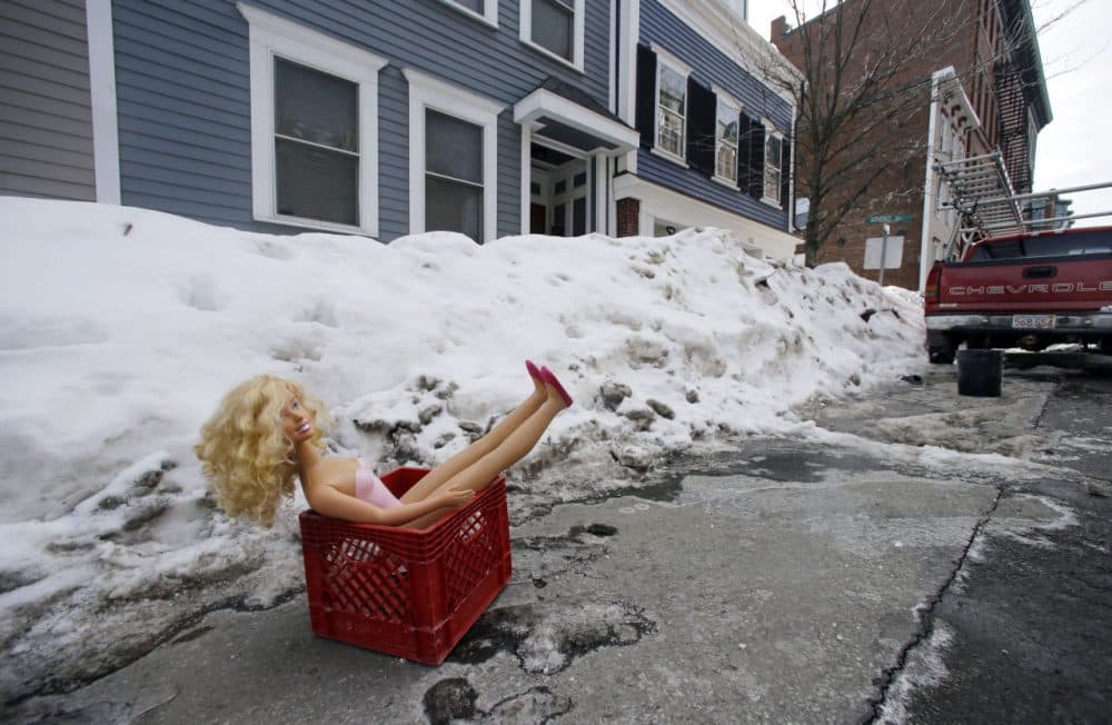 A doll in a milk crate saves a parking space on a residential street in South Boston last month. (Elise Amendola/AP)