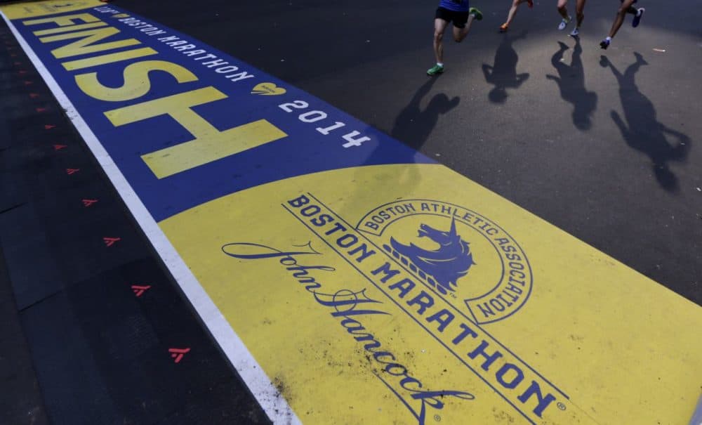 Runners approach the finish line of the Boston Marathon during a 5K race in 2014. (Charles Krupa/AP)