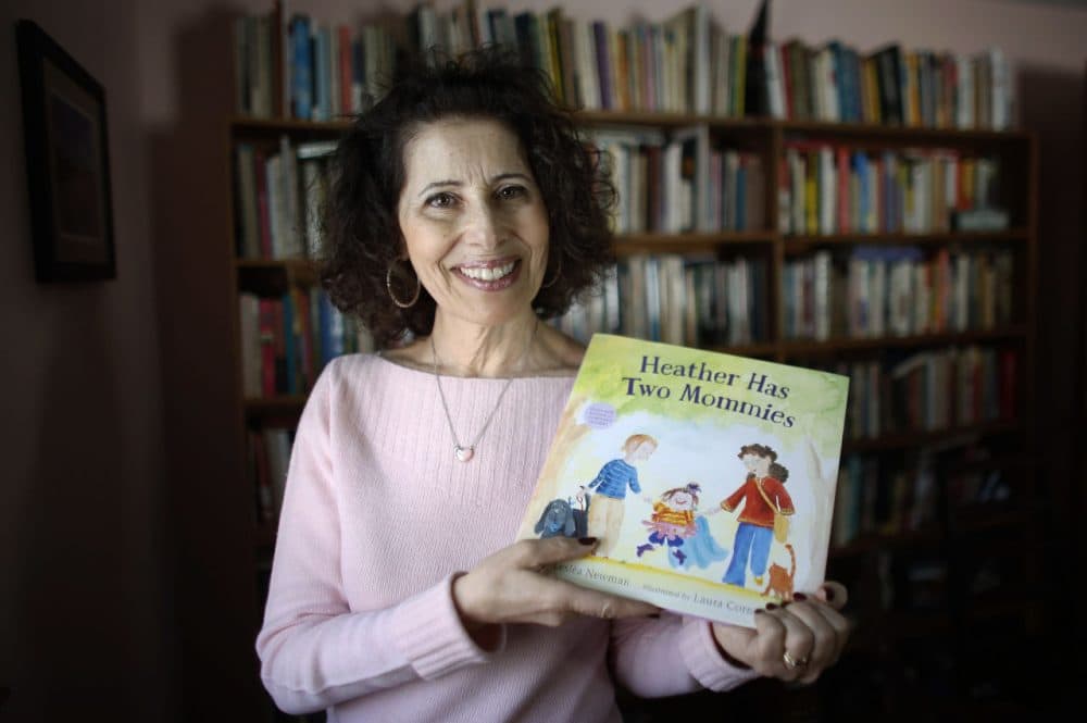 Author Leslea Newman, of Holyoke, Mass., displays a copy of her book &quot;Heather Has Two Mommies.&quot; (Steven Senne/AP)