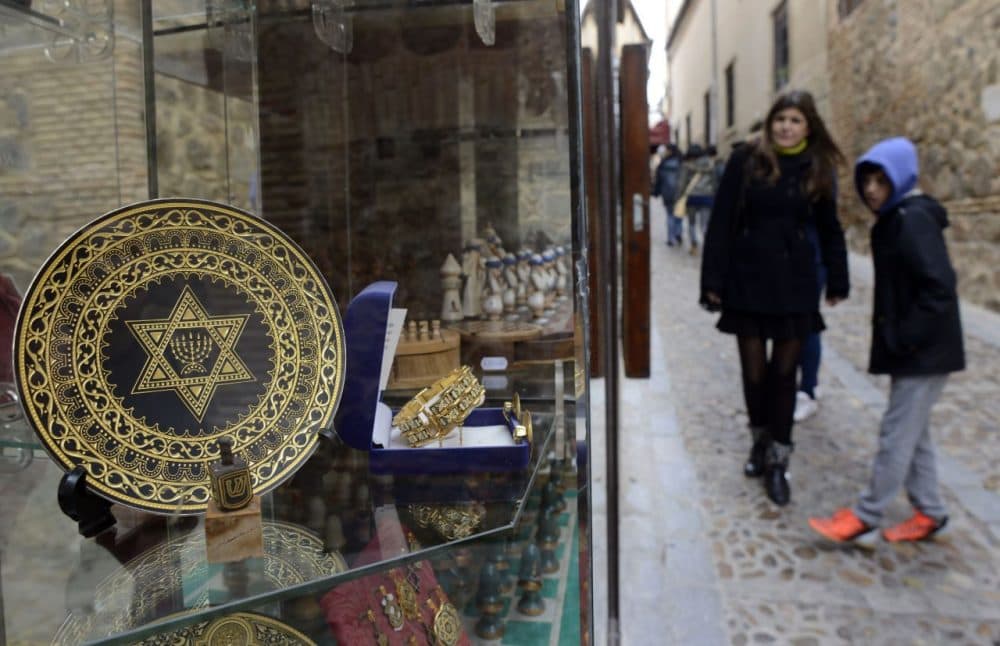 People stand near a gift shop in the old Jewish Quarters of Toledo on February 27, 2014. (Gerard Julien/AFP/Getty Images)